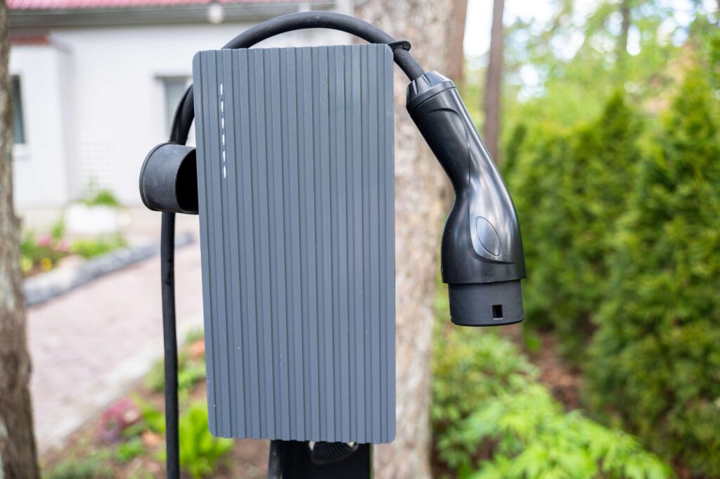 Outdoor EV charging station installed at a residential property in Adelaide, mounted near a driveway and garden.
